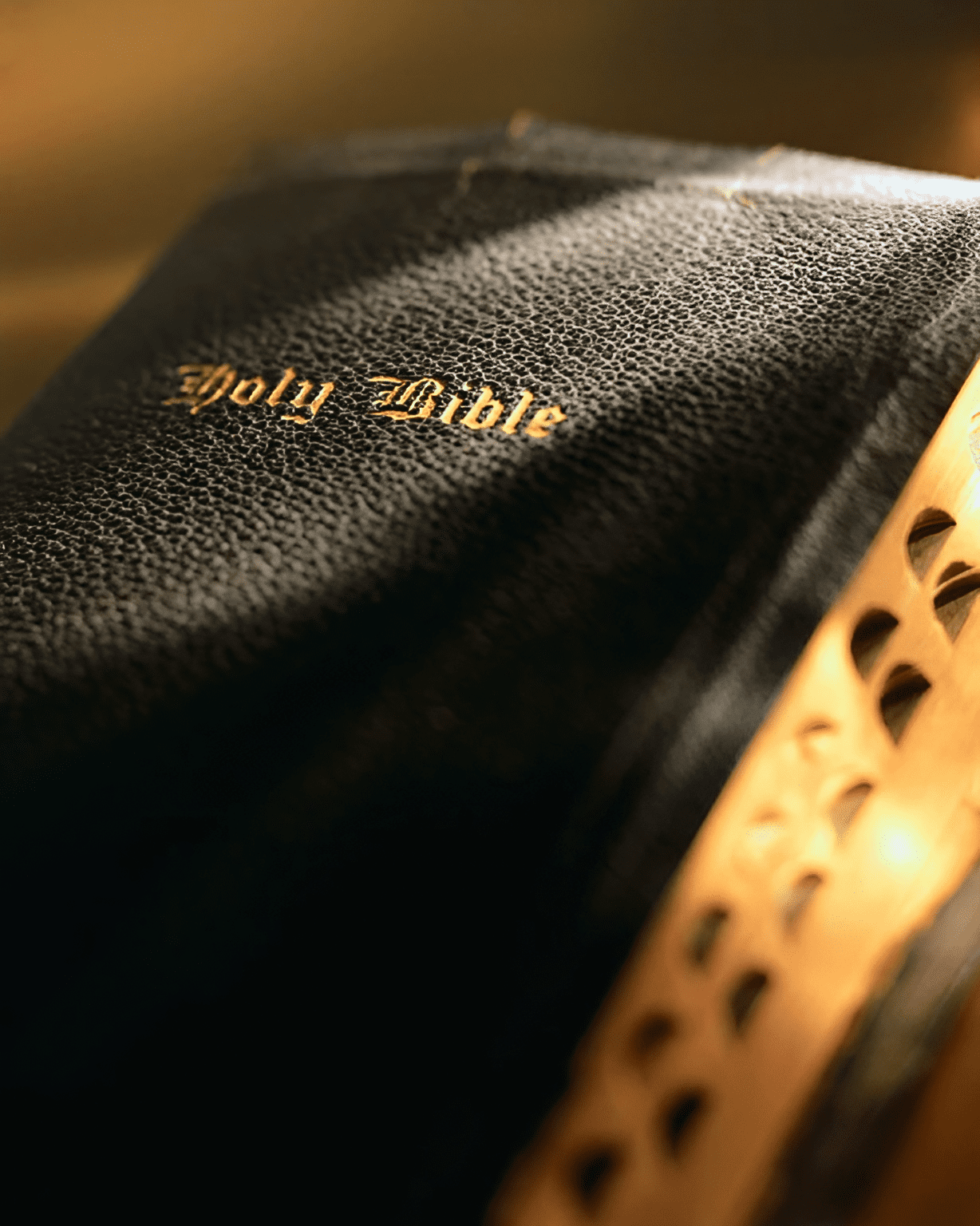 A close up of the bible on top of it.