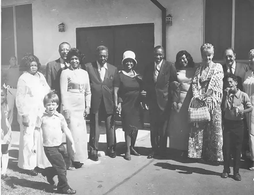 A group of people standing in front of a building.